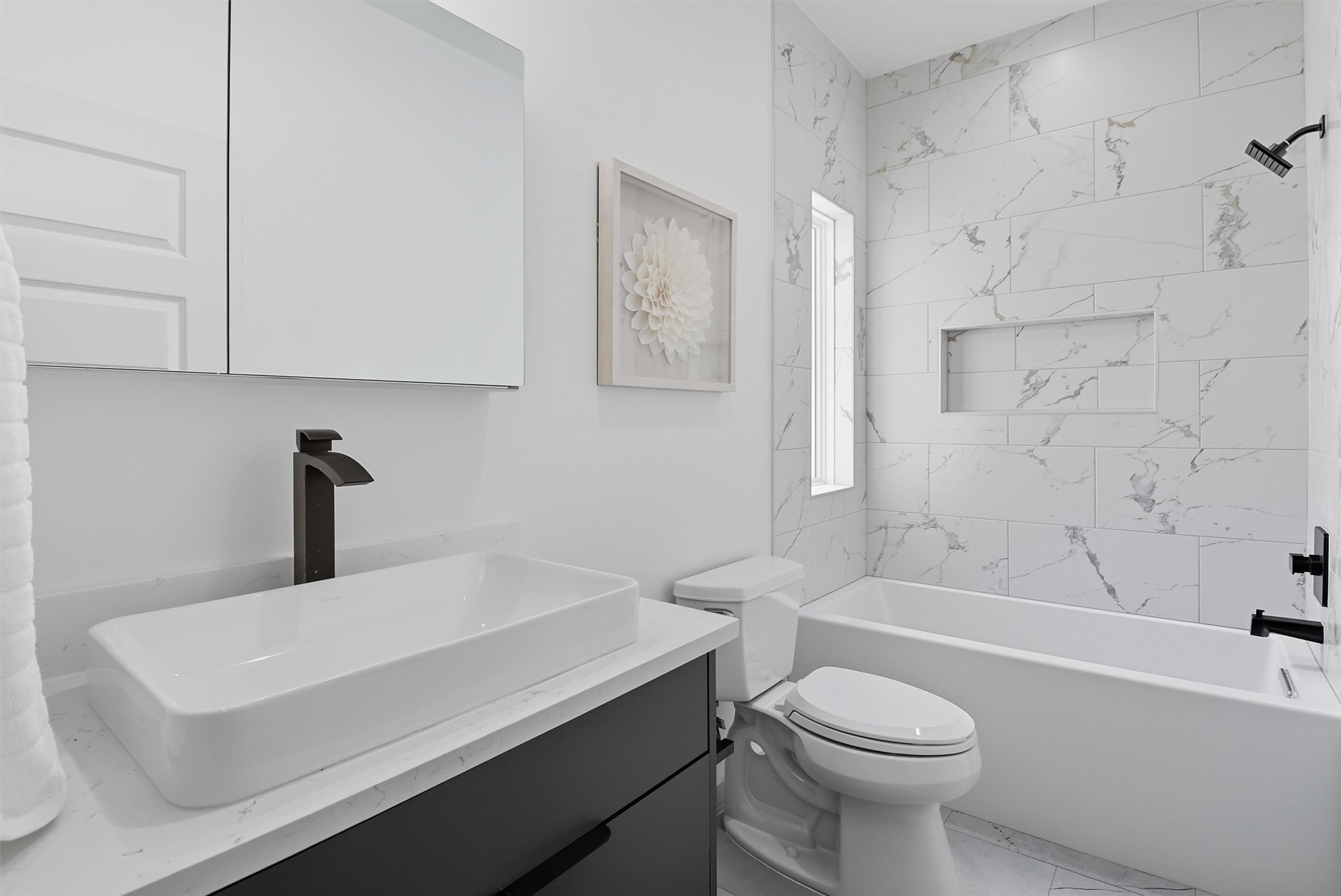 2939 El Fenice Lane Houston, TX 77057 - Photo 36 of 48 a bathroom with a sink a toilet and a bathtub