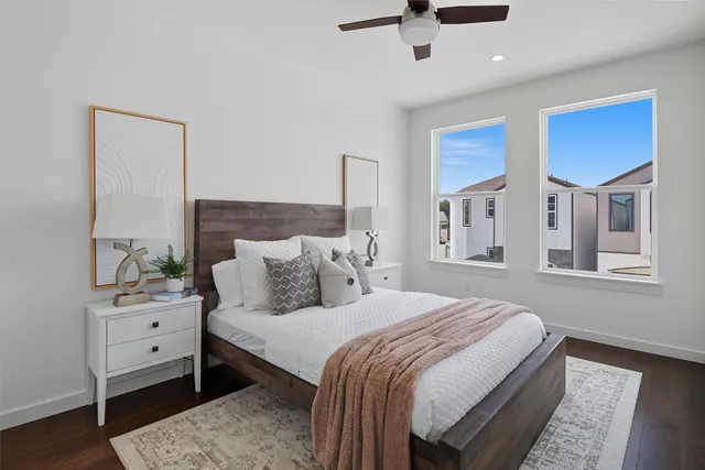 a bedroom with a bed and a painting on the wall