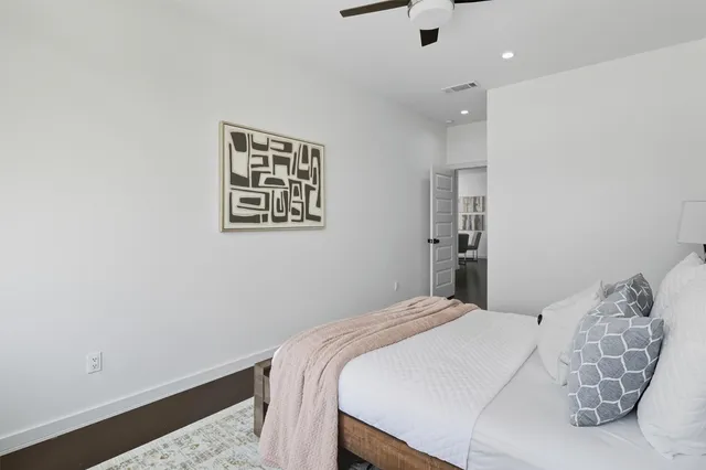 a living room with a baby crib furniture and a wooden floor
