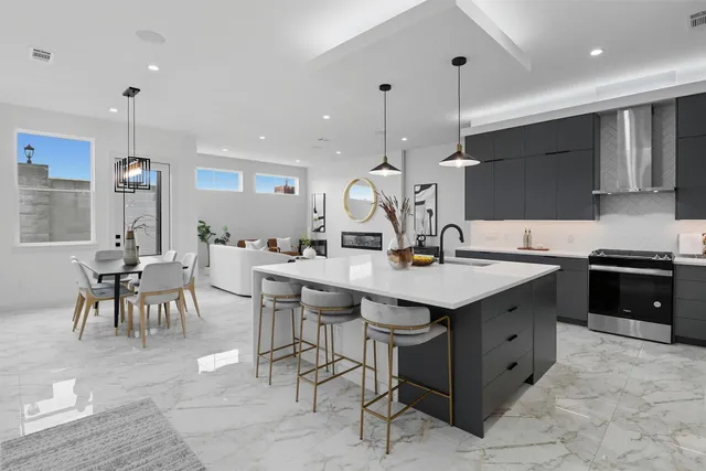 a kitchen with a sink a counter space appliances and cabinets