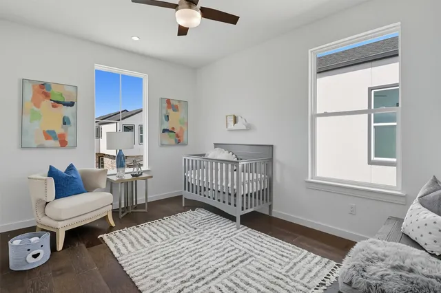 a bedroom with furniture and wooden floor