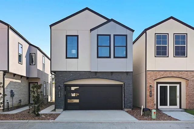 a front view of a house with garage