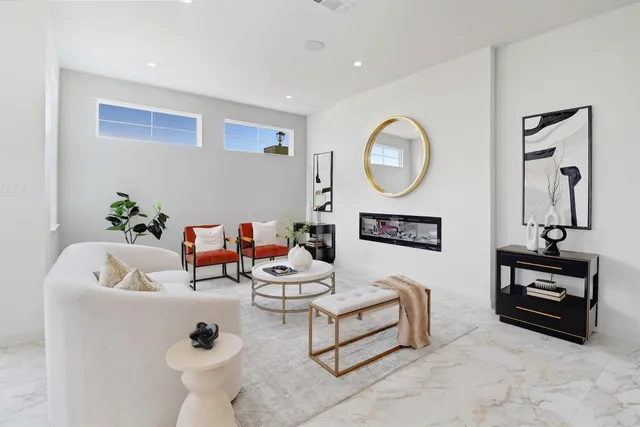 a living room with furniture and a mirror