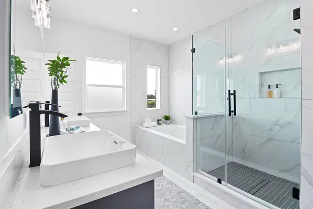 a bathroom with a bathtub a sink and a shower