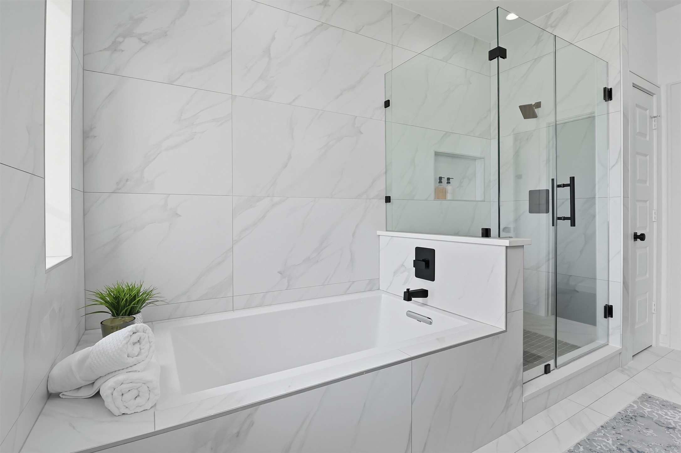 2939 El Fenice Lane Houston, TX 77057 - Photo 10 of 48 a white bath tub sitting next to a white sink and a shower