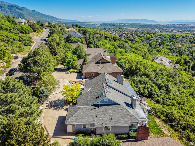 5057 South Ridgedale Drive Ogden, UT 84403 - Photo 55 of 69 Property featuring a multi-level design with a gray shingled roof and brick chimneys