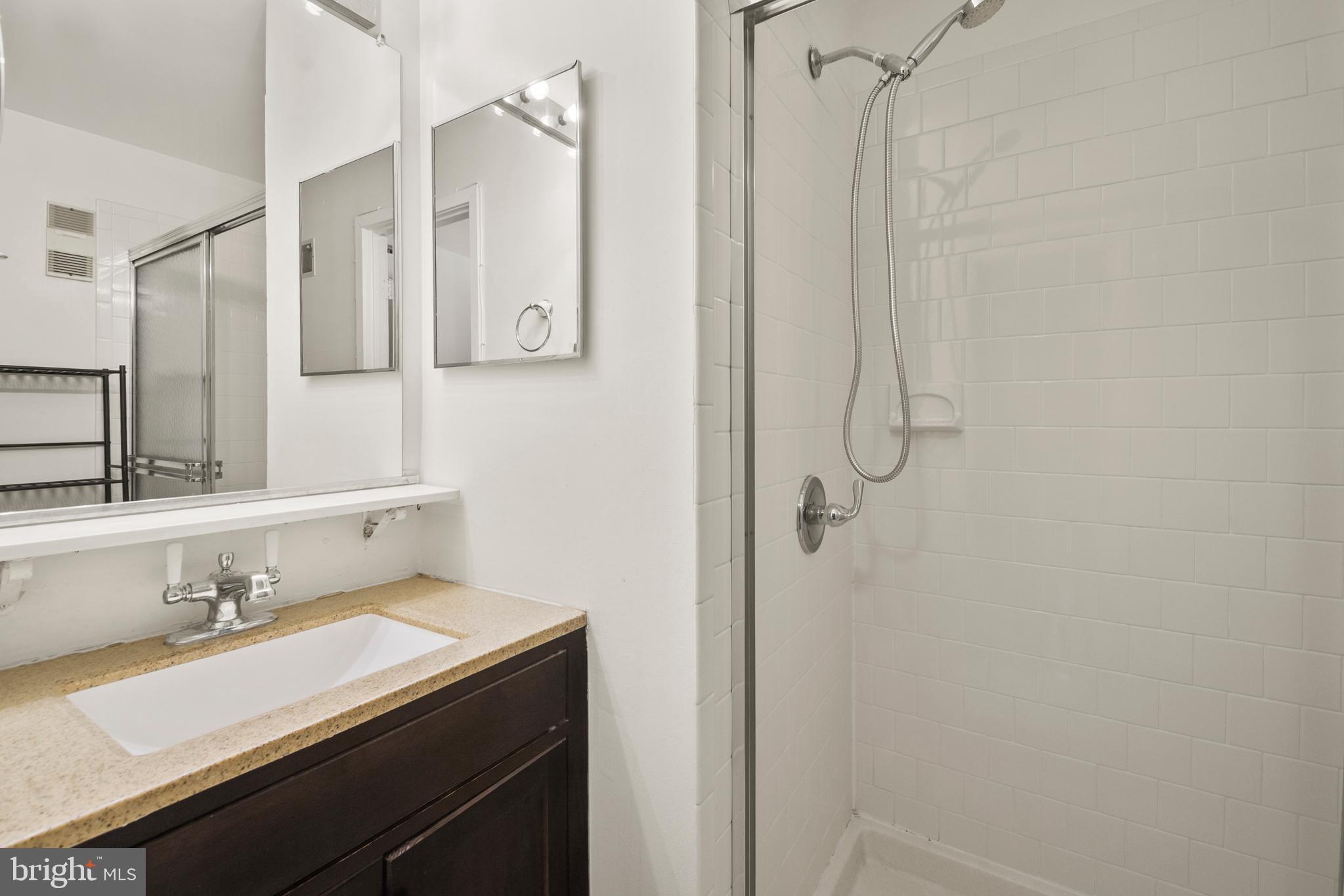 123 West Conway Street, Unit R 58 Baltimore, MD 21201 - Photo 16 of 20 a bathroom with a granite countertop sink mirror and double