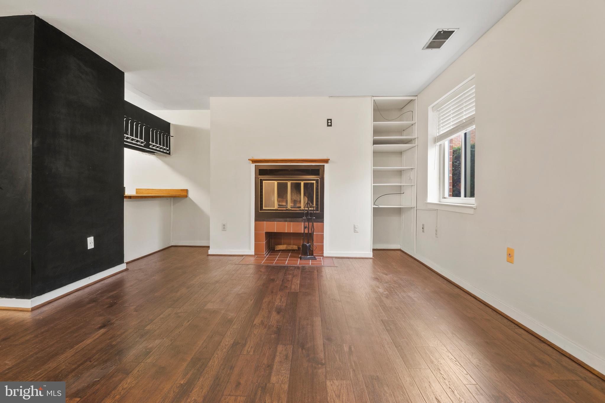 123 West Conway Street, Unit R 58 Baltimore, MD 21201 - Photo 3 of 20 an empty room with wooden floor and windows