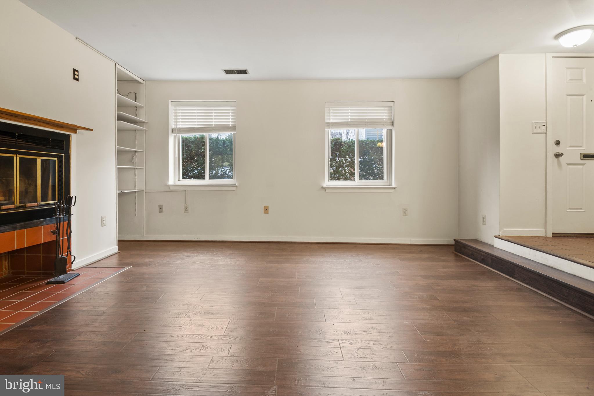 123 West Conway Street, Unit R 58 Baltimore, MD 21201 - Photo 7 of 20 an empty room with wooden floor and windows