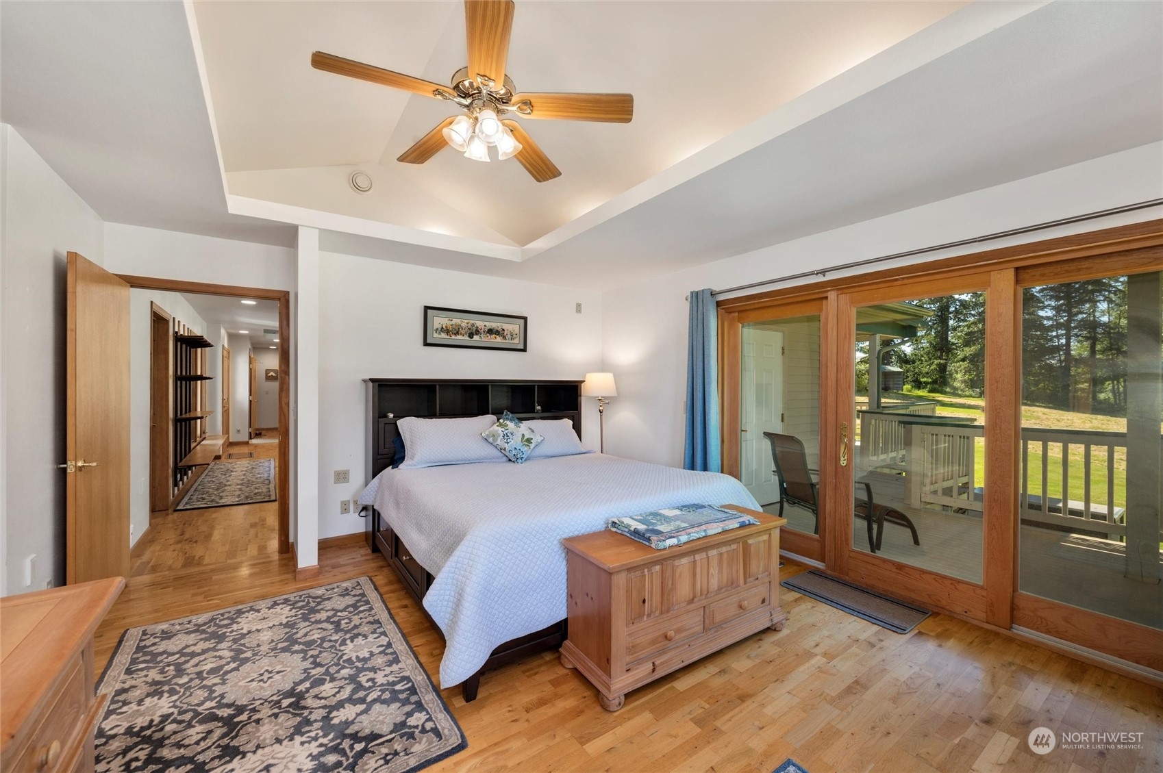 7445 Valley View Road Ferndale, WA 98248 - Photo 12 of 39 a bedroom with a large bed and a chandelier