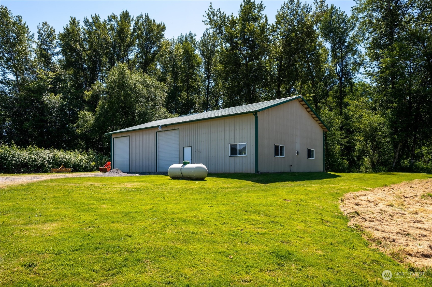 7445 Valley View Road Ferndale, WA 98248 - Photo 22 of 39 a backyard of a house with large trees and wooden fence