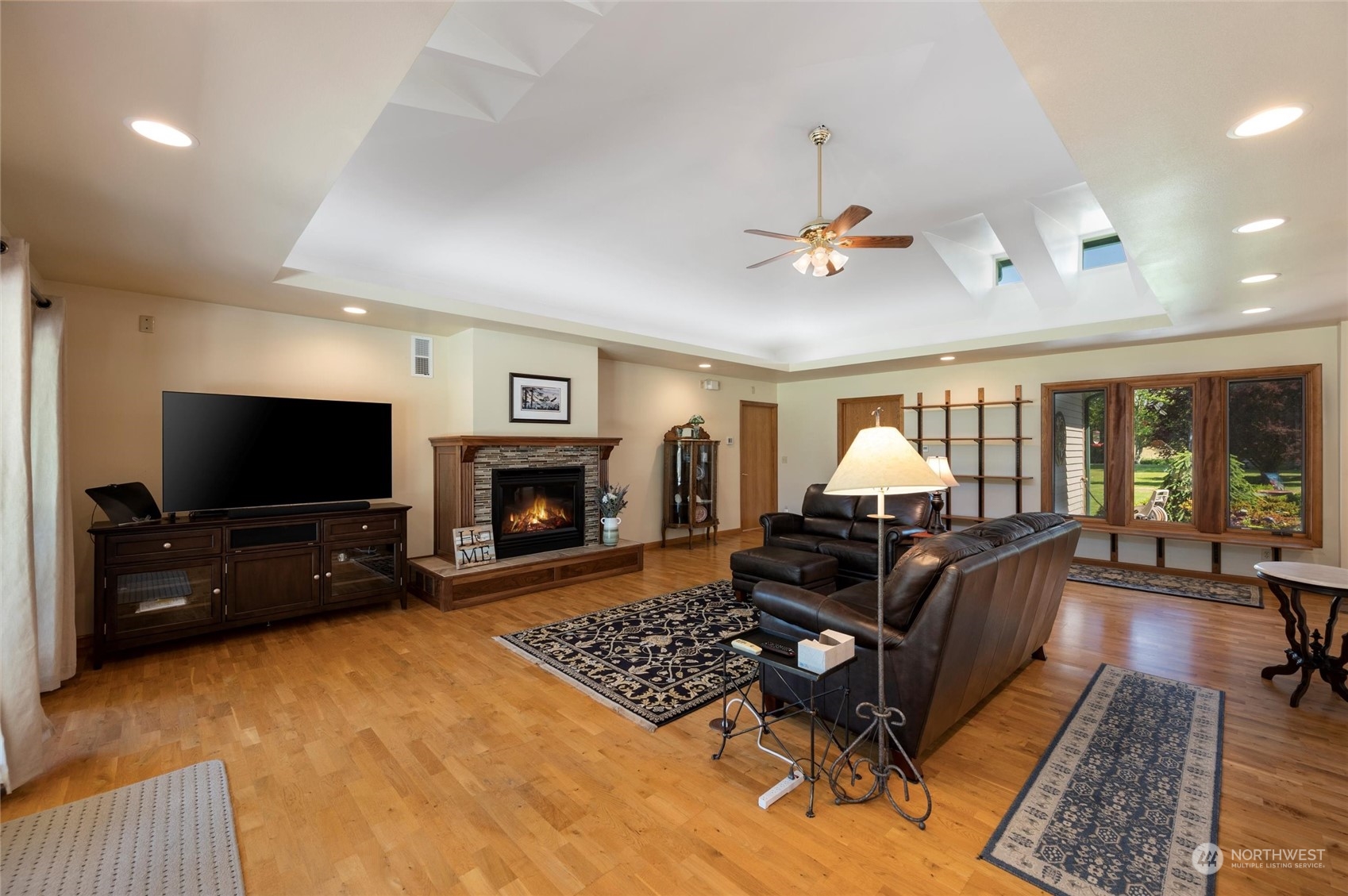 7445 Valley View Road Ferndale, WA 98248 - Photo 5 of 39 a living room with furniture a flat screen tv and a fireplace