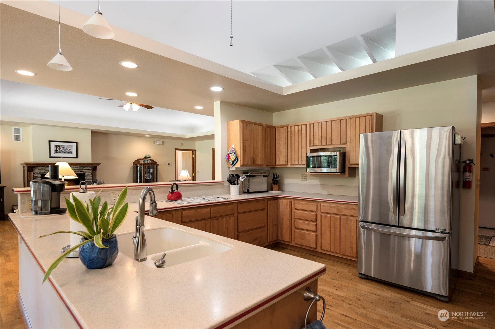 7445 Valley View Road Ferndale, WA 98248 - Photo 7 of 39 a kitchen with stainless steel appliances granite countertop a refrigerator a sink a stove and white cabinets
