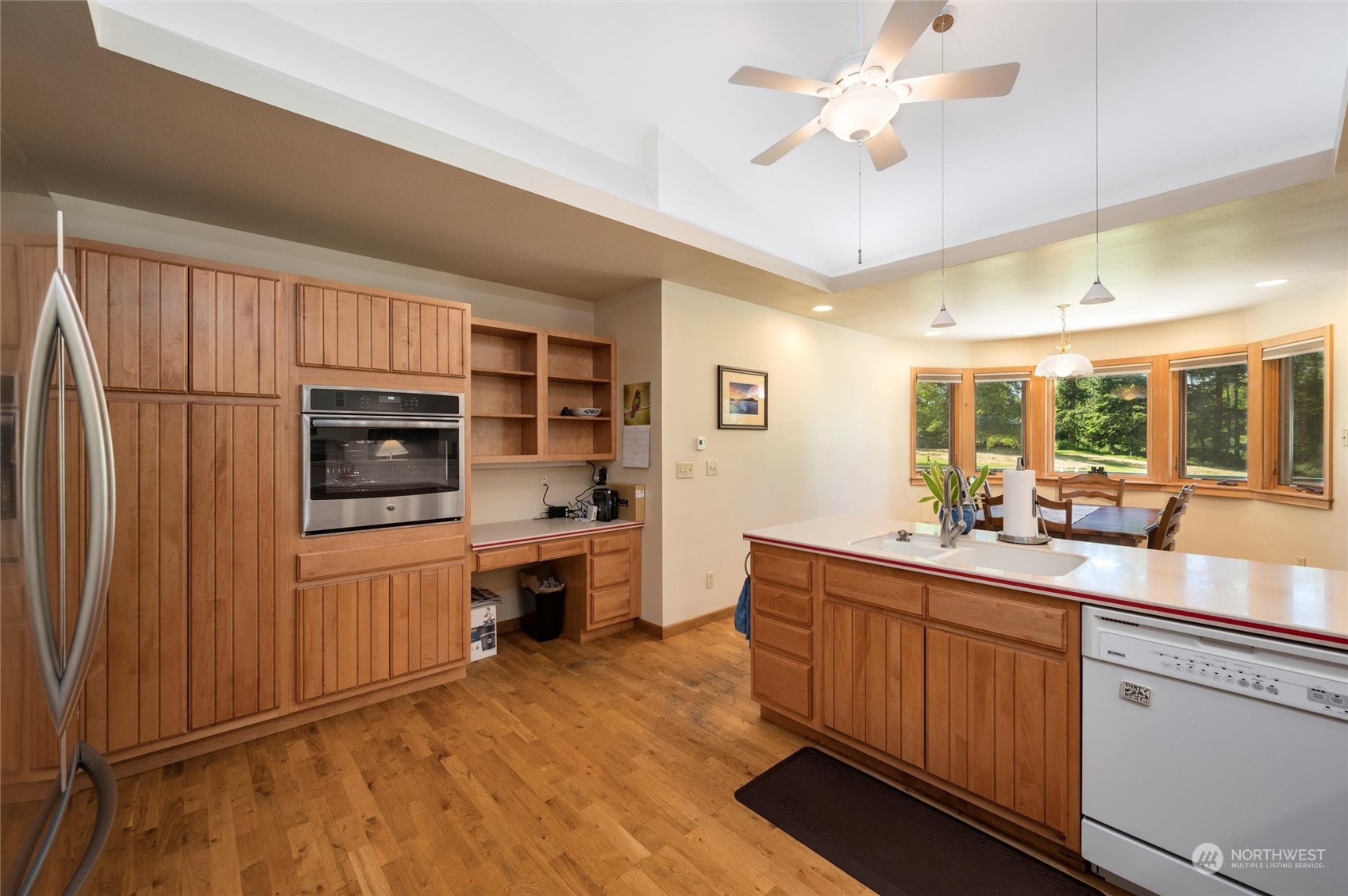 7445 Valley View Road Ferndale, WA 98248 - Photo 9 of 39 a kitchen with stainless steel appliances a sink a stove a refrigerator cabinets and a dining table