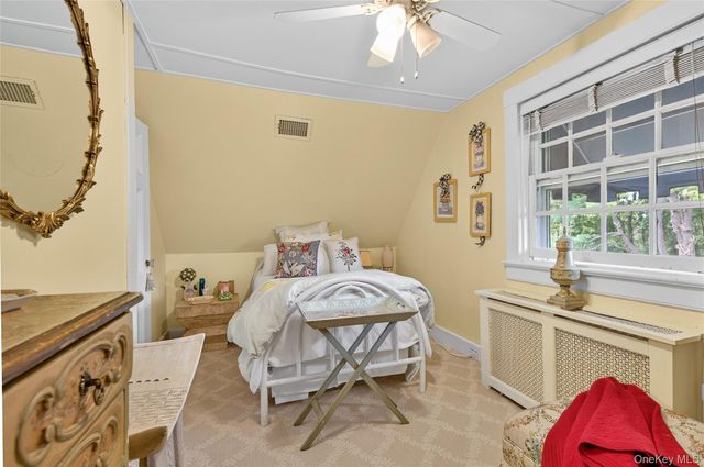 a bedroom with a bed and a table chair