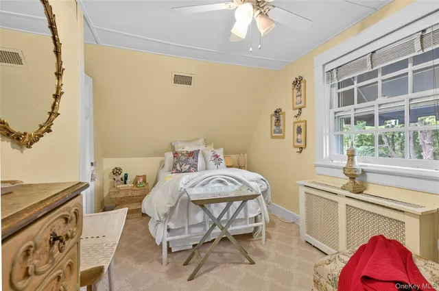 a bedroom with a bed and a table chair