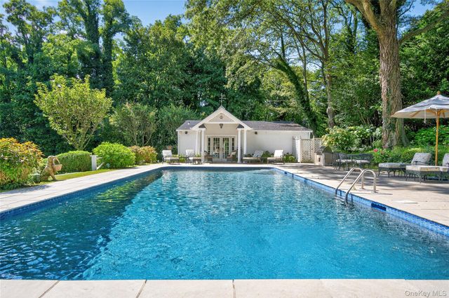 a house with swimming pool in front of it