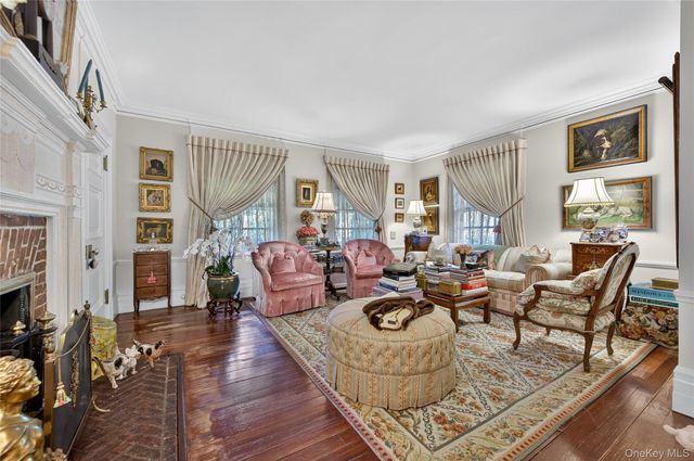 a living room with fireplace furniture and a wooden floor