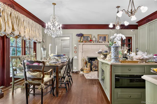 a view of a dining room with furniture wooden floor and chandelier