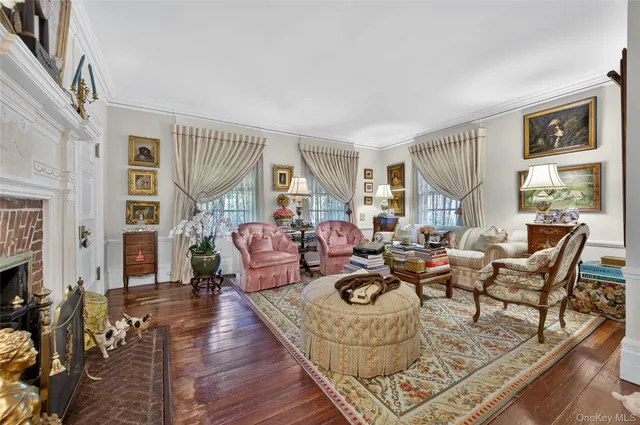 a living room with fireplace furniture and a wooden floor