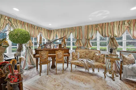 a living room with furniture a large window and a table