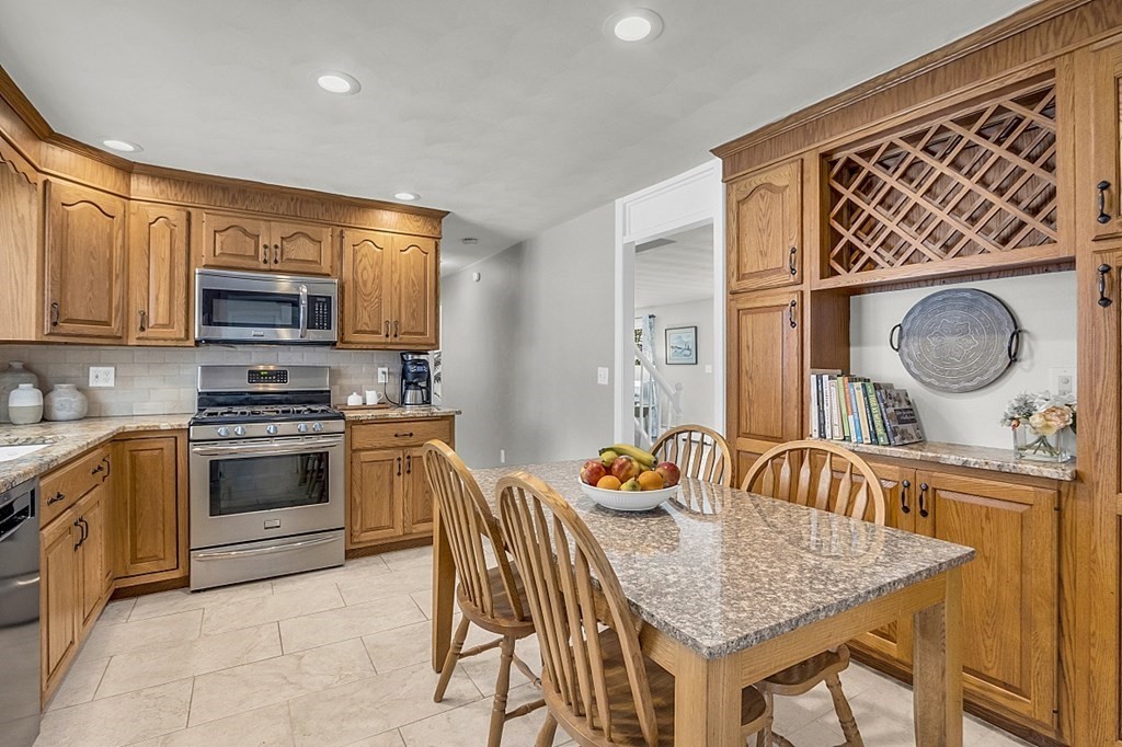 25 Ansie Road Chelmsford, MA 01824 - Photo 19 of 41 a kitchen that has a sink and a stove with wooden floor