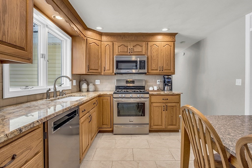 25 Ansie Road Chelmsford, MA 01824 - Photo 20 of 41 a kitchen with stainless steel appliances granite countertop a stove sink and cabinets