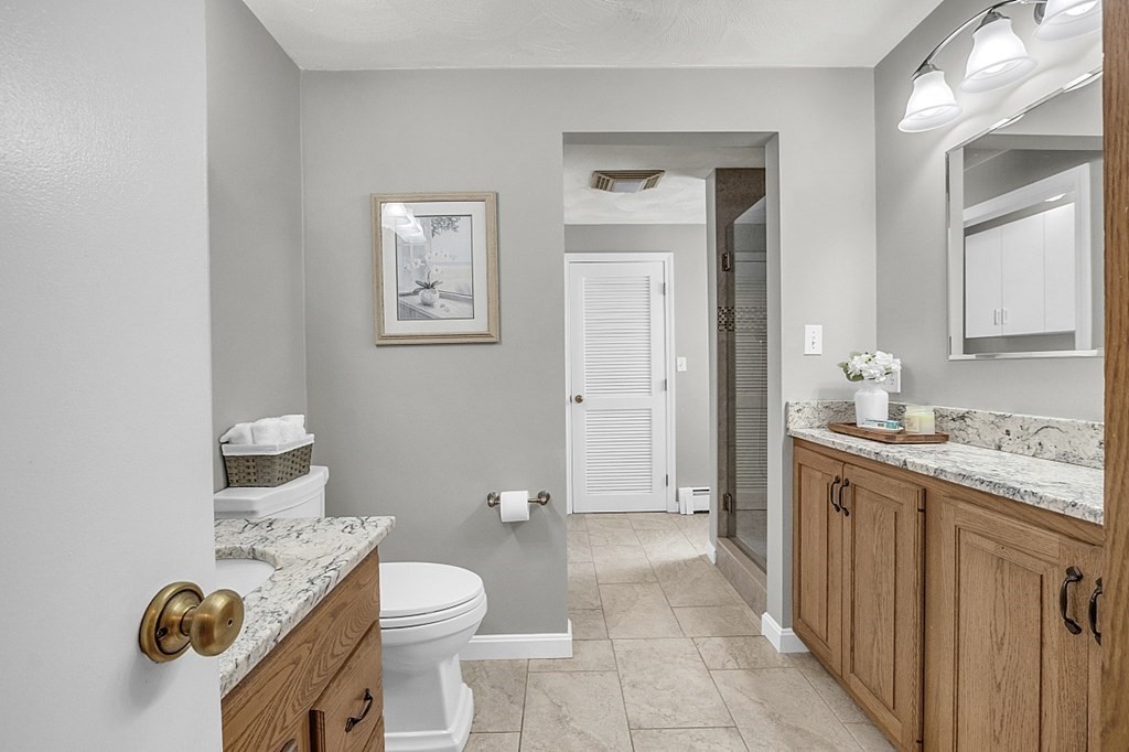 25 Ansie Road Chelmsford, MA 01824 - Photo 27 of 41 a spacious bathroom with a toilet a sink and mirror