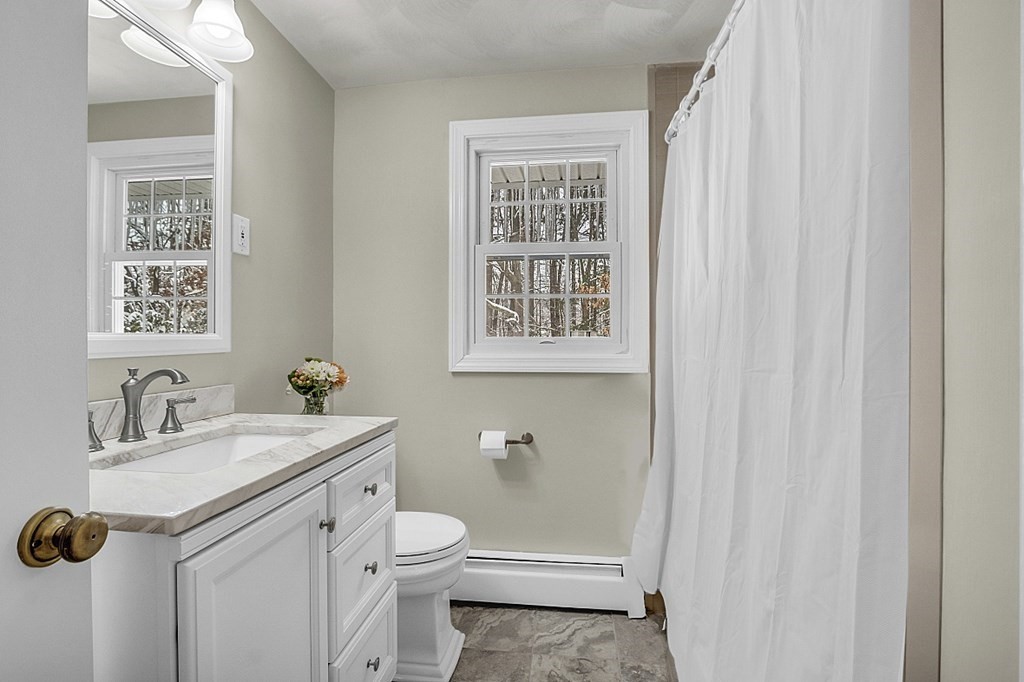 25 Ansie Road Chelmsford, MA 01824 - Photo 32 of 41 a bathroom with a sink a toilet and a window