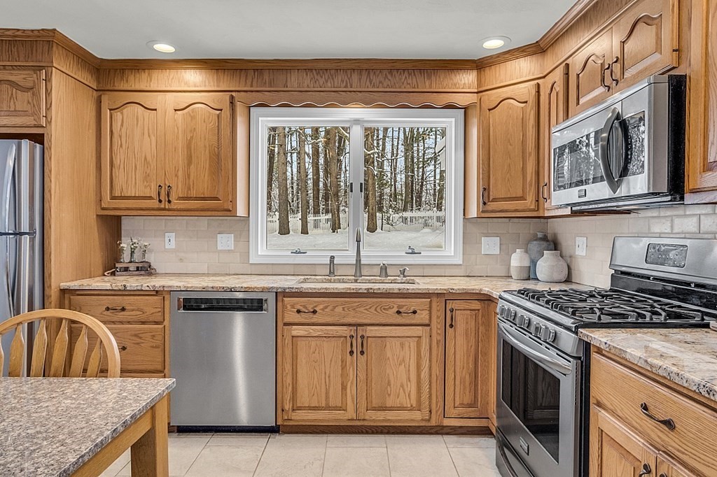 25 Ansie Road Chelmsford, MA 01824 - Photo 5 of 41 a kitchen with granite countertop a sink stove top oven and cabinets