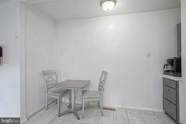 a view of a room with a table and chairs