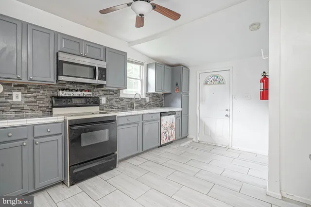 a kitchen with a stove sink and microwave
