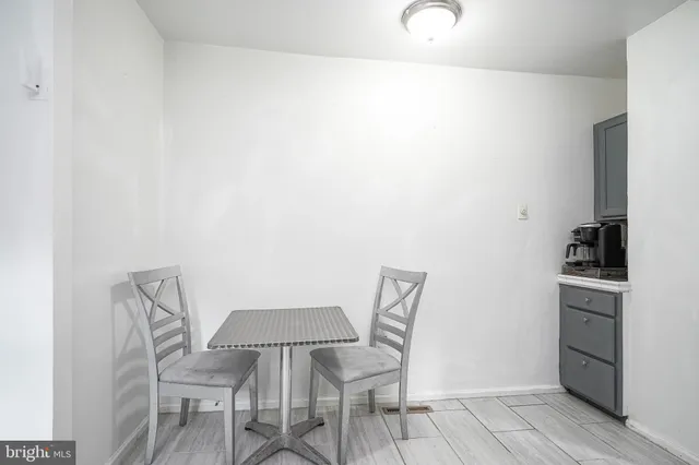 a view of a room with furniture and wooden floor