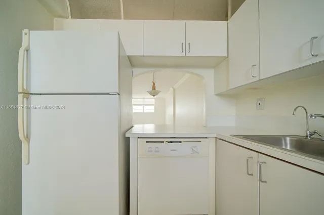 a white refrigerator freezer sitting inside of a kitchen