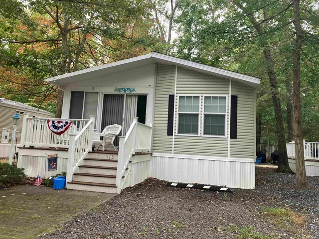 a view of a house with a yard and stairs