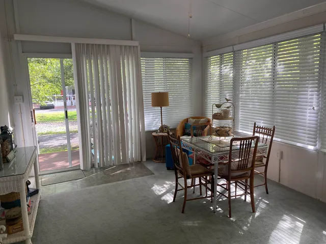 a view of a dining room with furniture and a window