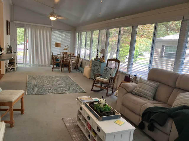 a living room with furniture and a floor to ceiling window