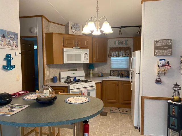 a kitchen with a sink a stove and chairs