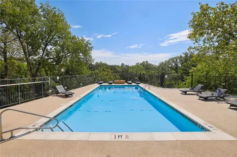 a view of swimming pool with a lounge chair