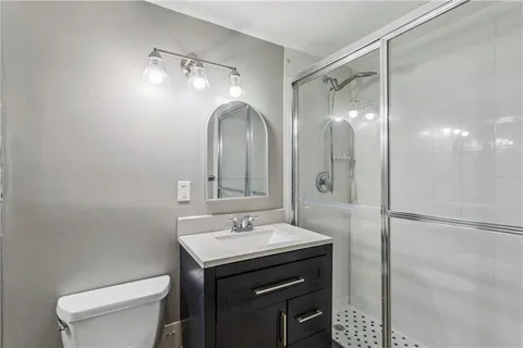 a bathroom with a sink toilet and shower