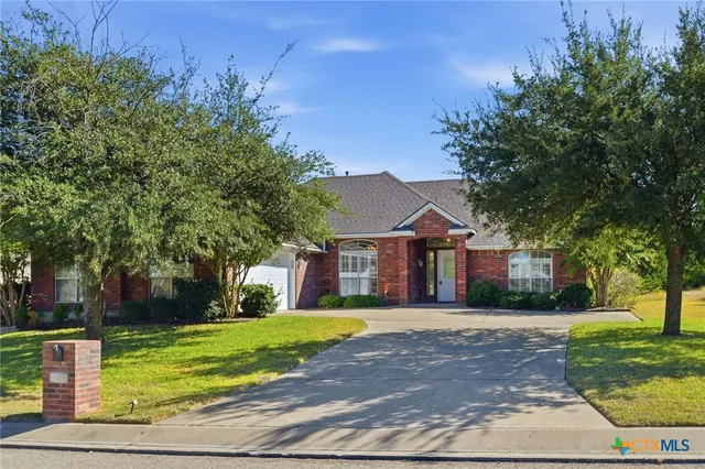 a front view of house with yard and green space