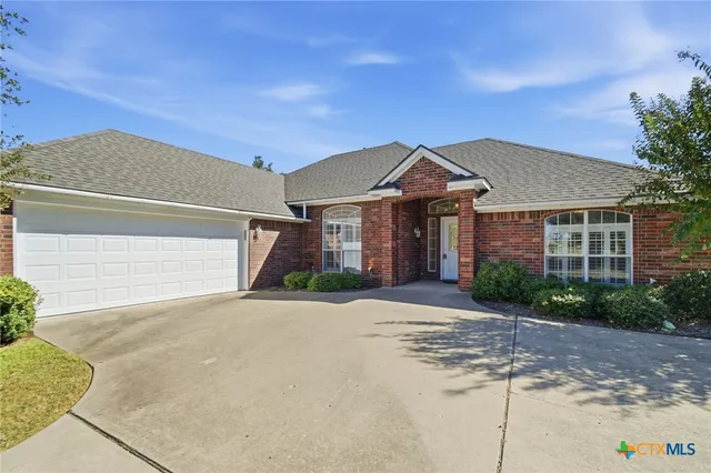 a front view of a house with a yard and a garage
