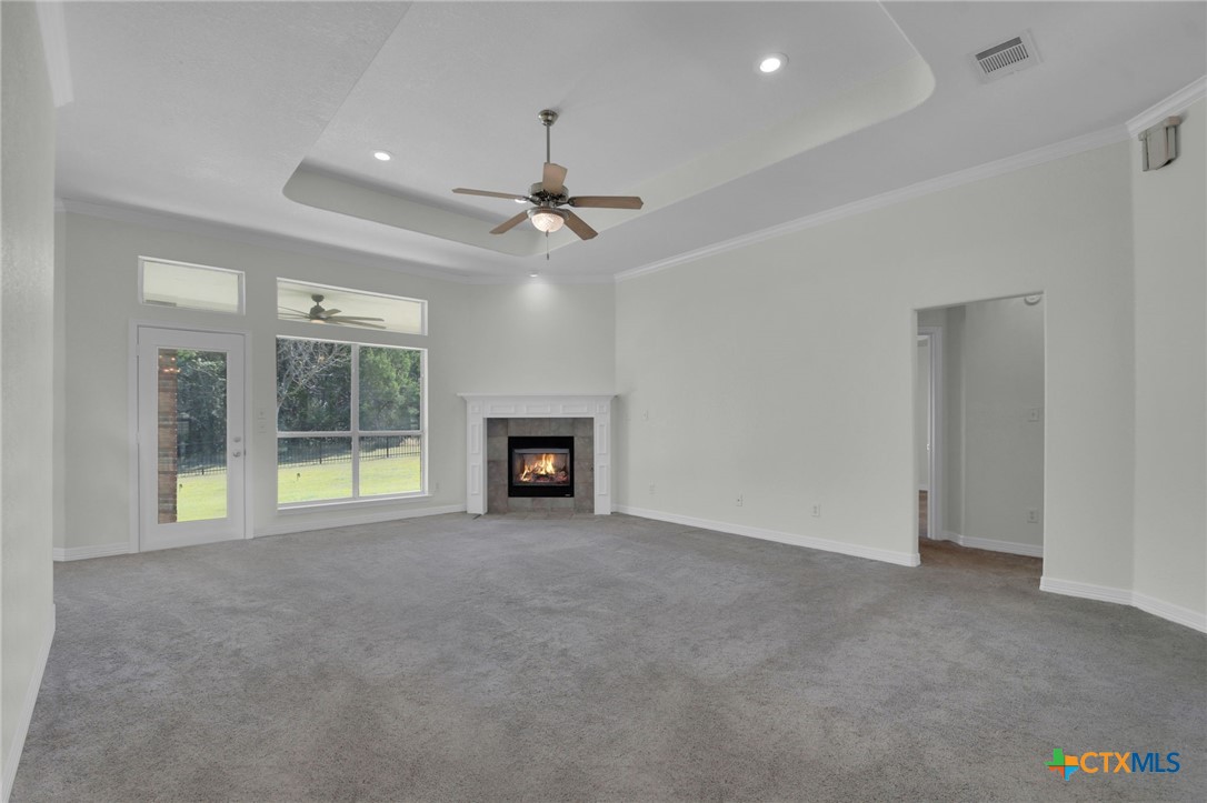 4703 Sunflower Lane Temple, TX 76502 - Photo 9 of 35 an empty room with fireplace and windows