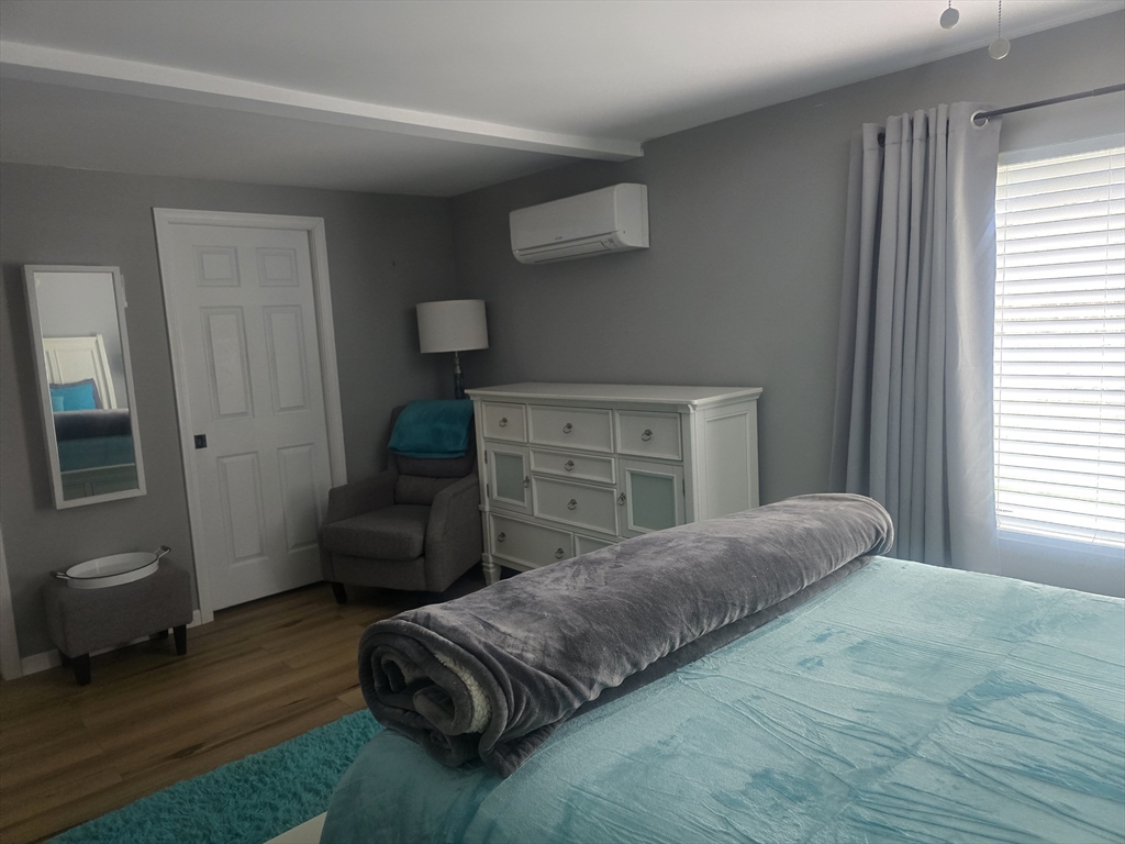 855 Somers Road East Longmeadow, MA 01028 - Photo 4 of 10 a bedroom with a bed and wooden floor