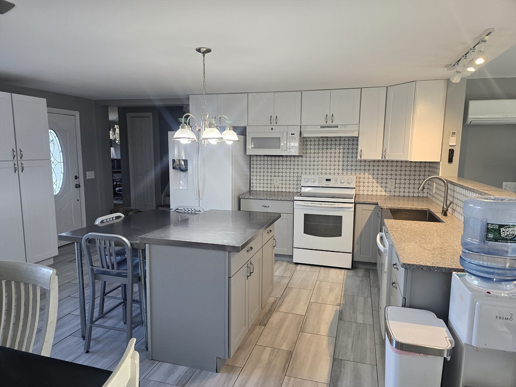 855 Somers Road East Longmeadow, MA 01028 - Photo 8 of 10 a kitchen with a stove a sink and a refrigerator