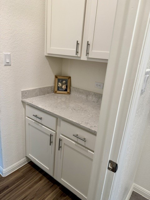 2016 Wooded Run Trail Georgetown, TX 78628 - Photo 6 of 16 Laundry area featuring white shaker cabinetry, brushed nickel hardware, light-toned countertop, and wood-finish flooring