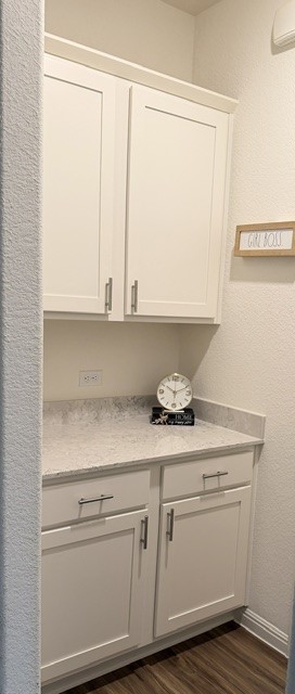 2016 Wooded Run Trail Georgetown, TX 78628 - Photo 7 of 16 White shaker-style cabinetry with brushed nickel hardware, light-toned countertop, wood-finish flooring, and crown molding