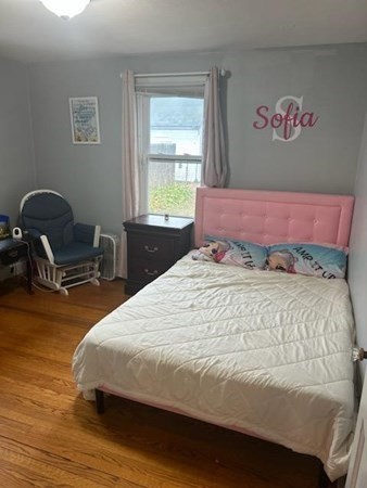 179 Powell Avenue Springfield, MA 01118 - Photo 15 of 30 a bedroom with a bed and a chair