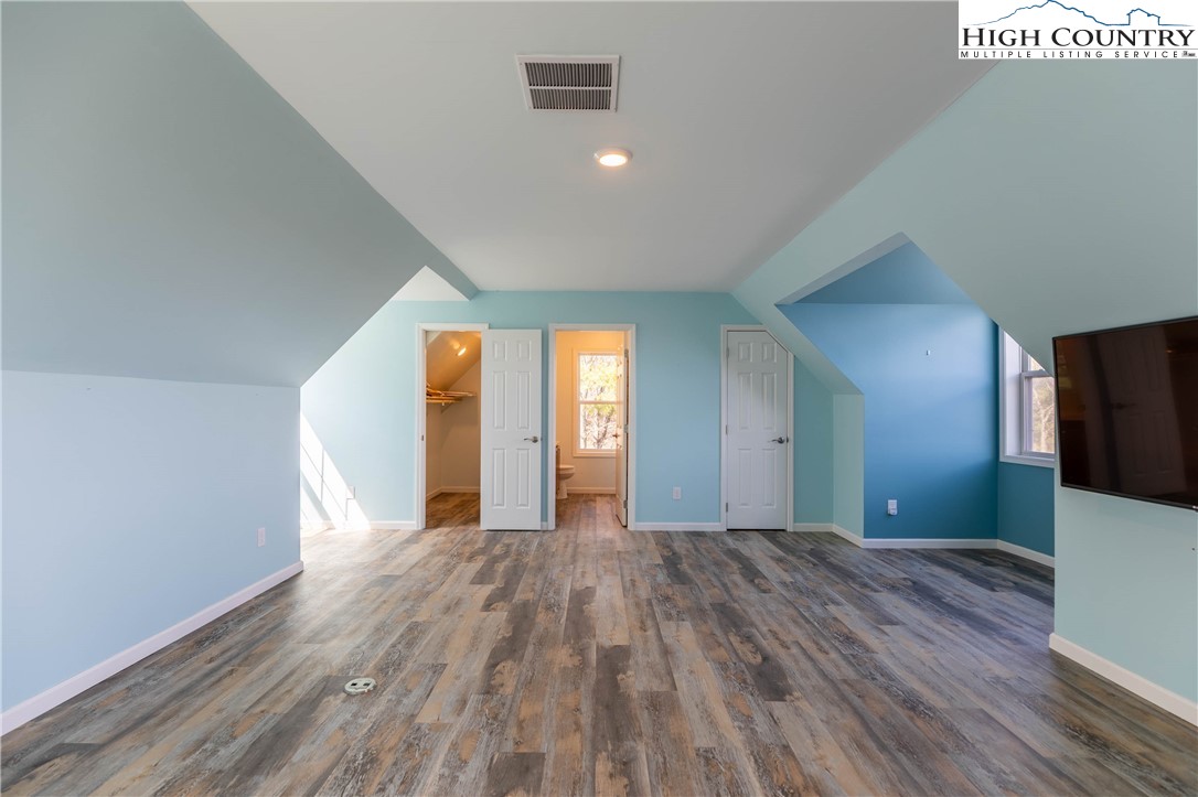 449 Meadow Ridge Drive Jefferson, NC 28640 - Photo 22 of 37 a view of a big room with wooden floor and windows