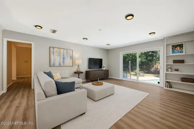 a living room with furniture and a flat screen tv